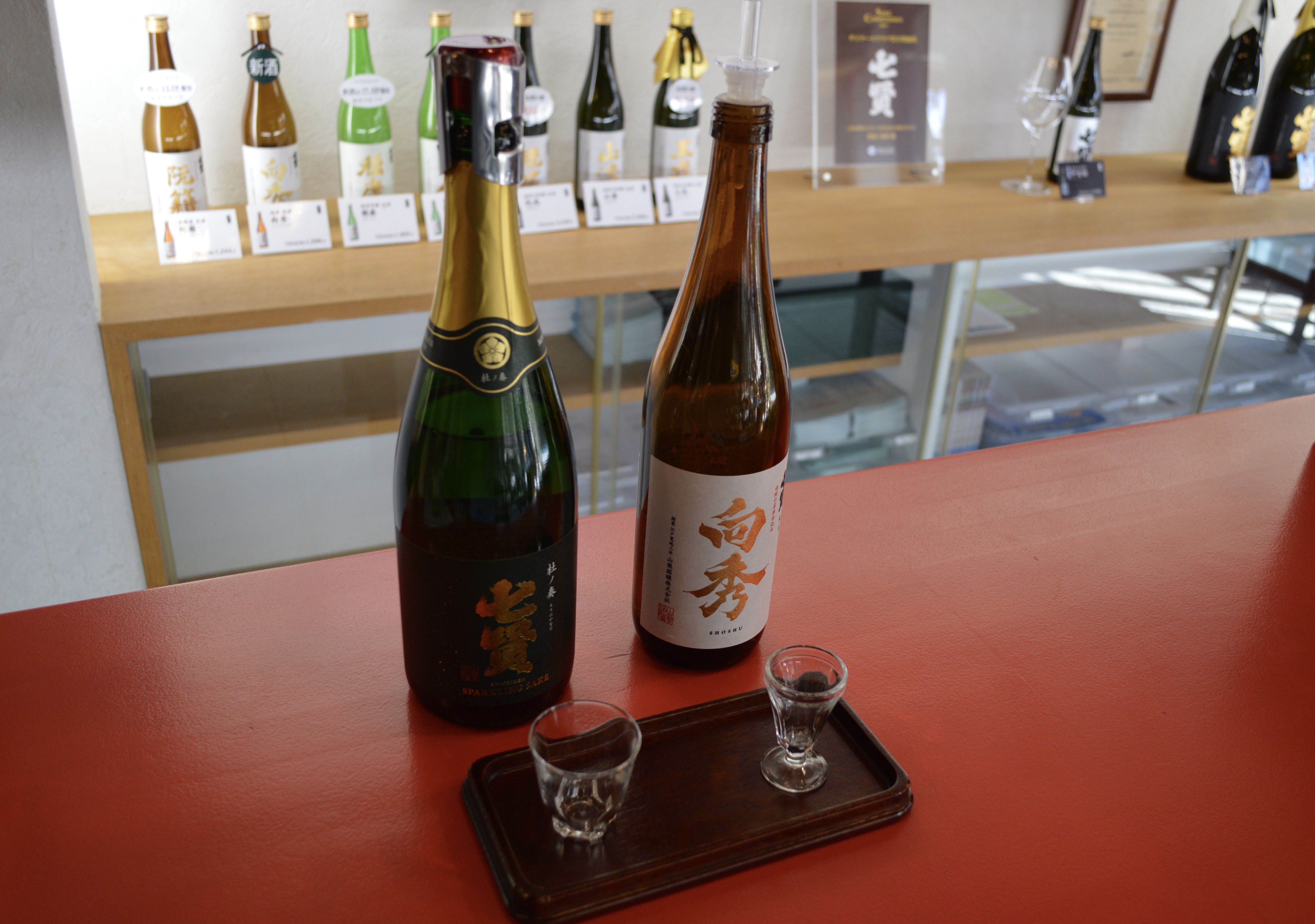 Ryogo Kitahara has also developed a sparkling sake that has its initial fermentation in oak barrels (left).